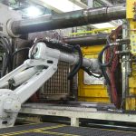 Large tonnage plastics molding in process.