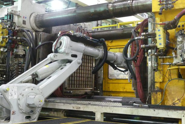 Large tonnage plastics molding in process.